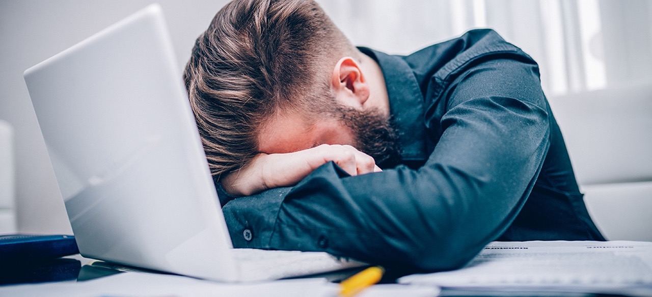 Man is loosing it with head on his computer